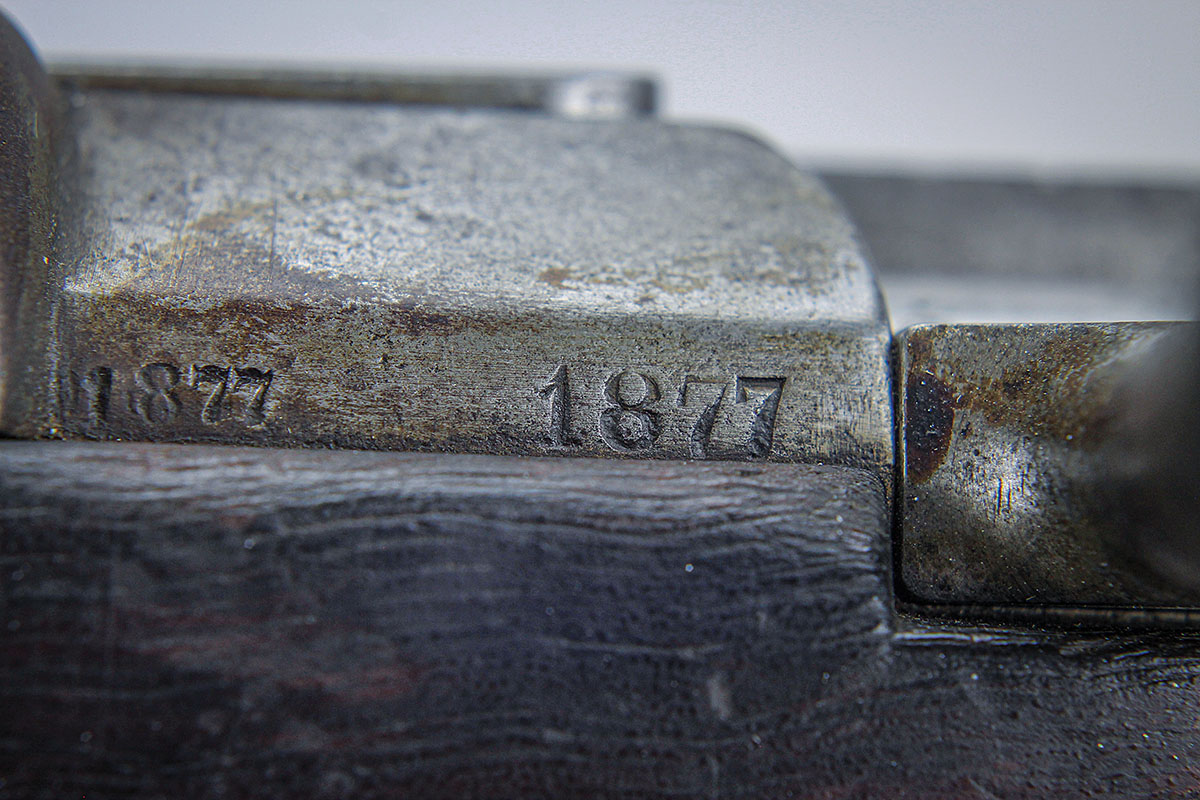 The manufacture date is “1887”. Visible to the right, the bolt’s only locking lug, the bolt guide, bears against the receiver.